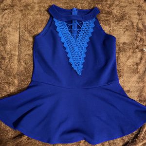 A Peplum Top With Lace Detail On Neck