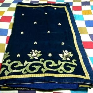 IT IS A NAVY BLUE WOMEN'S SAREE....