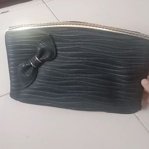 Black clutch bag with solid gold finish