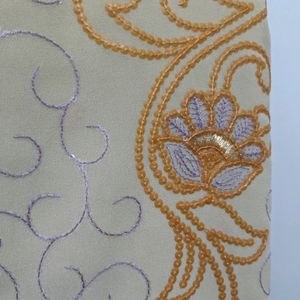 Cream And Orange Embroidery Saree