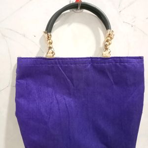 A Purple Colour Handbag. U Can Carry It With Saree