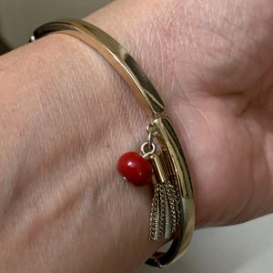 Elegant Metallic Bracelet With a Red Bead