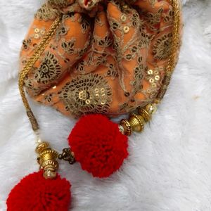 Radiant Elegance: Orange & Golden Potli Bag