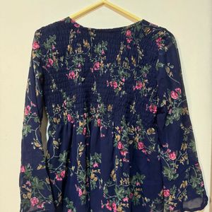 This is a navy blue long-sleeved blouse