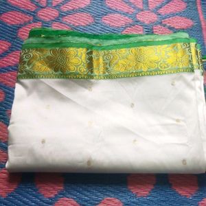 White Saree With Green And Golden Design