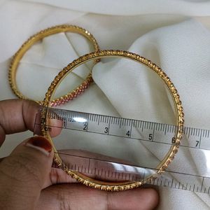 A Rose Gold Bangle With Ros Stones