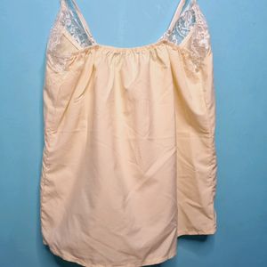 Cream Cami Top With Net Design On Neck.