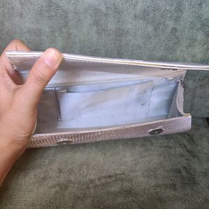 Silver Clutch. There are very few stains over it i