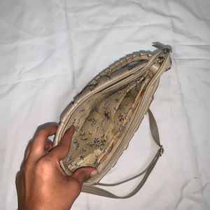 Beige Cremish Sling Bag.