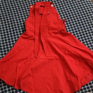 A Dungaree Dress In Bright Red