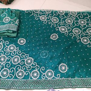 bottle green net saree with blouse and lehnga