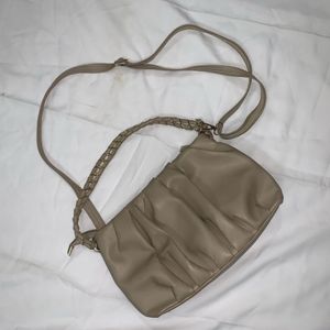 Beige Cremish Sling Bag.