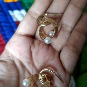 Golden earrings with white beads