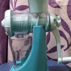 Manual Fruit Juicer With A Glass Tubler