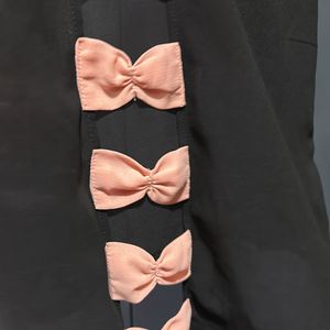 Black Top With Pink Bow In Back Side Of To