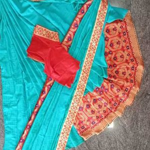 A Beautiful Sky Blue Saree With Red Flower Border