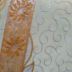 Cream And Orange Embroidery Saree