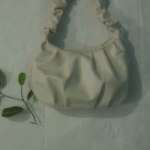 A Beige Side Bag.