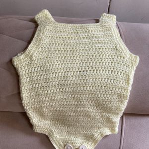 A Crochet Set Of Romper, Bonnet And Booties