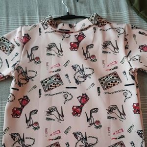 Women Baby Pink Top With Printed Feminine Graphic