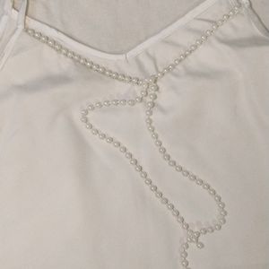 White top with pearl detail