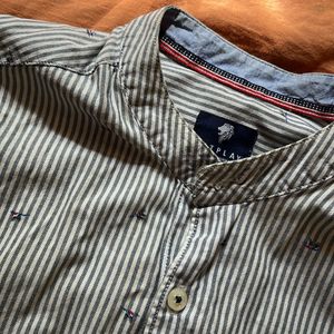 A Full Sleeve Shirt With Vertical Stripes.