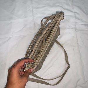 Beige Cremish Sling Bag.