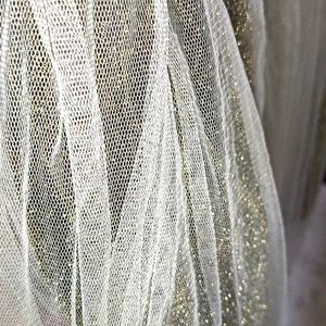 A Skirt In Net Metalic Gold Colour With Whitenet