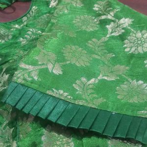 Green colour soft brocade padded blouse . It has princess cut in the front ruffles on sleeves