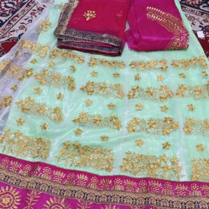 Net Lahenga With Net Dupatta And Raw Silk Blouse Piece