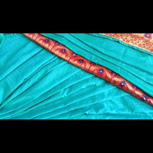 A Beautiful Sky Blue Saree With Red Flower Border