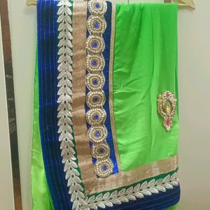 A Green Saree With Blue Border