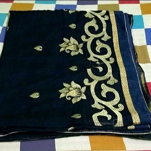 IT IS A NAVY BLUE WOMEN'S SAREE....