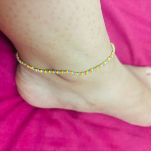 Anklet With Blue, Orange, Yellow Bids