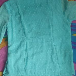 An Aqua Blue Top With Flared Sleeves