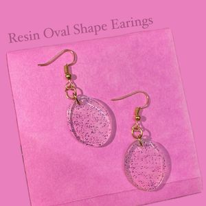 Resin Oval Shape Earings With Blue Glitters.