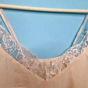 Cream Cami Top With Net Design On Neck.