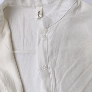 White shirt with red scallop detailing