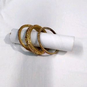 Set Of Three Bangles In Golden Color