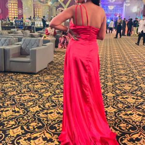 Beautiful hot red one sided shoulder gown made up of satin material with one sided high slit.