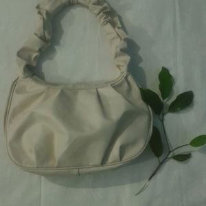 A Beige Side Bag.