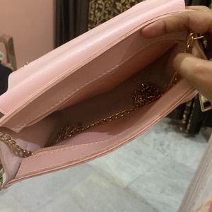 Baby pink sling bag.