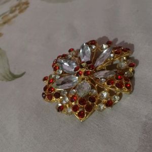 A Broach Of Metal With Diamonds