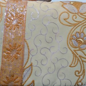 Cream And Orange Embroidery Saree