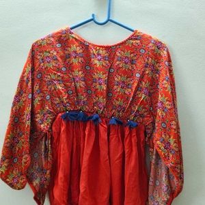 Printed Orange Top With Cut-out Cape Sleeves