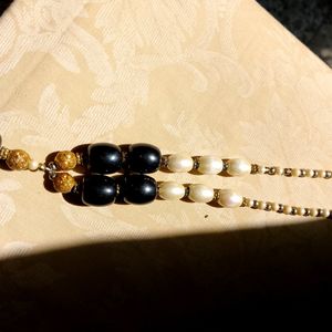 A Black nd White Pearl Necklace With Golden Work