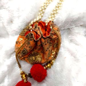 Radiant Elegance: Orange & Golden Potli Bag