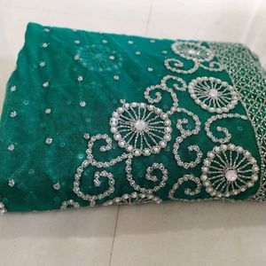 bottle green net saree with blouse and lehnga