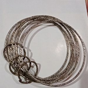 A Semi Black Neckpeice With Churi Bracelet.