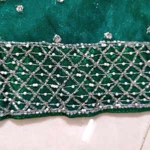 bottle green net saree with blouse and lehnga